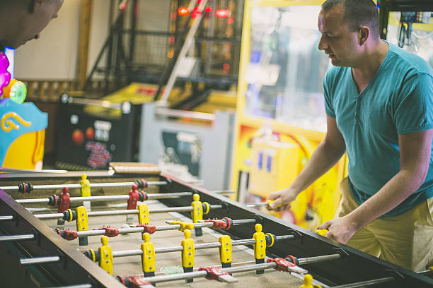 istock Friends having fun together playing table football. 639584068