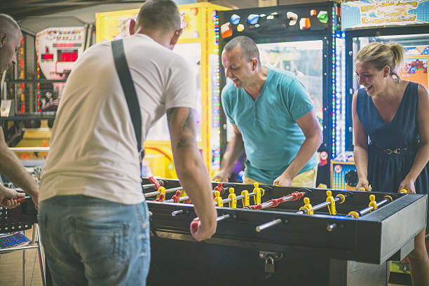 istock Friends having fun together playing table football. 639584346