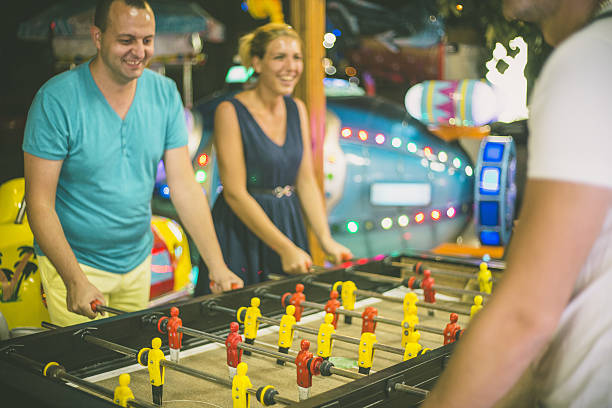 istock Friends having fun together playing table football. 639584540