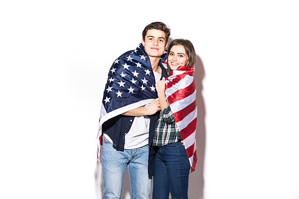 istock Young couple cover with US Flag 639588296