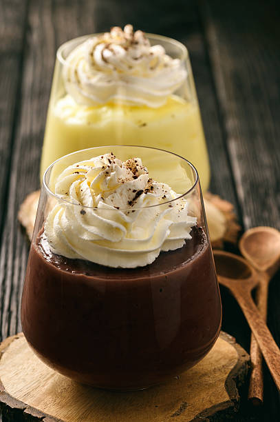 istock Cream and chocolate pudding with whipped cream on wooden background. 639588438
