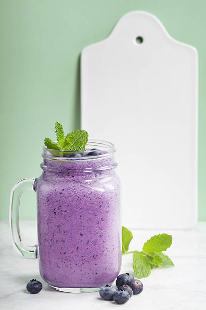 istock Blueberry smoothie and White ceramic serving board 639589126