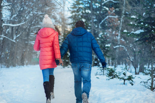 istock woman and man having fun in winter forest 639589292