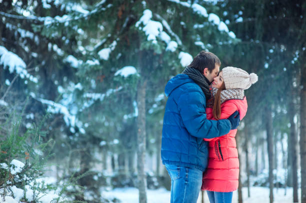 istock woman and man having fun in winter forest 639589568