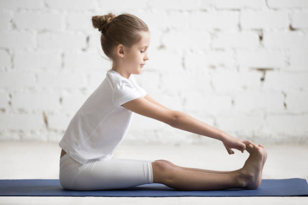 istock Girl child in paschimottanasana pose, white studio background 639589586