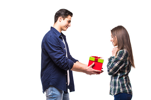 Young couple share gift on white background. Girl get present from her boufriend.