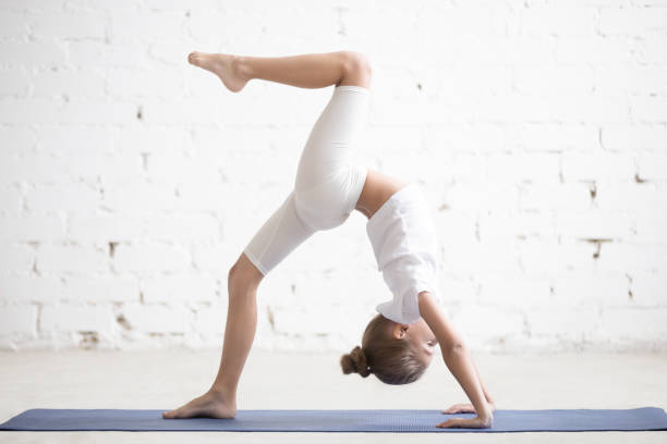 istock Girl child in One legged Wheel pose, white studio background 639591006