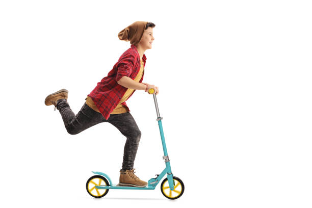 istock Happy boy riding a scooter 639591830