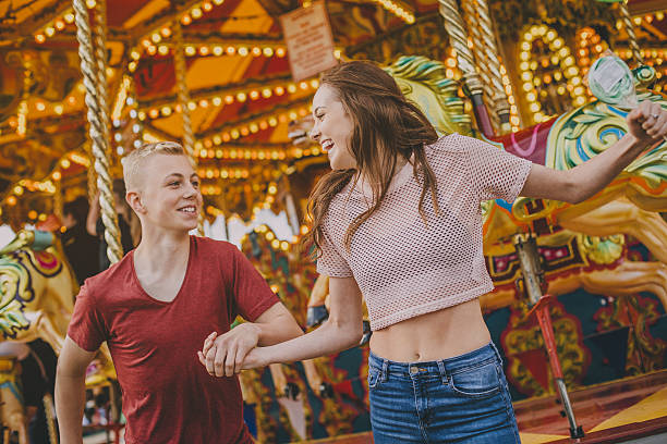 pareja en merry go alrededor! - affectionate desire beauty brown fotografías e imágenes de stock