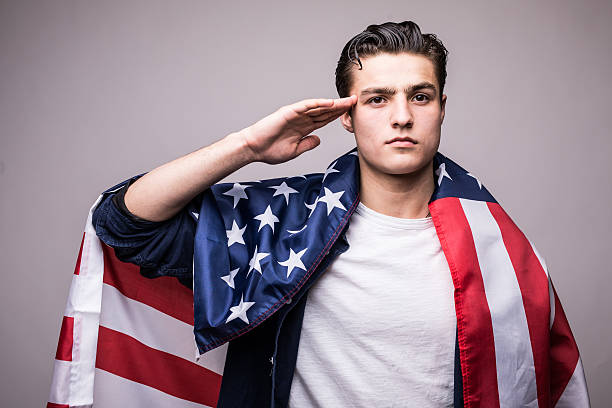 istock Man in american flag salutes 639594036