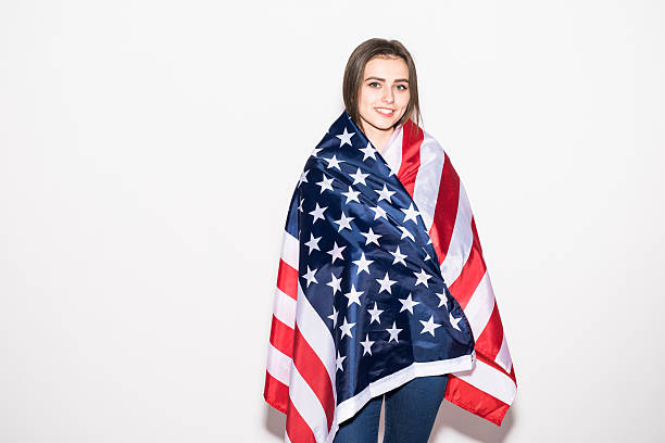 istock Young girl covered US flag on white 639594378