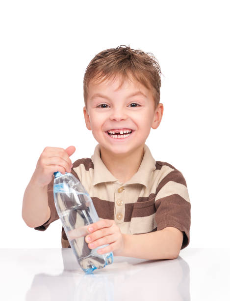 istock Little boy with plastic bottle of water 639595178