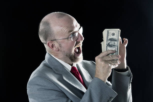 istock Man rejoices with dollars in hand 639601326