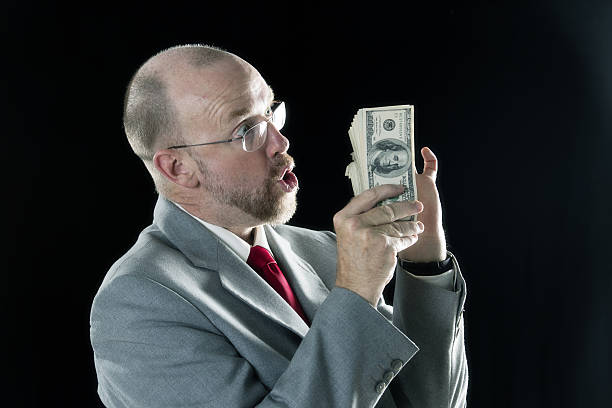 istock Middle aged man counts money 639601970