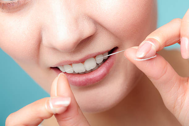 istock Woman smiling with dental floss. 639602084