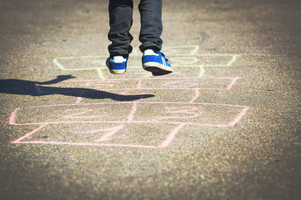 istock little boy playing hopscotch on playground 639602116