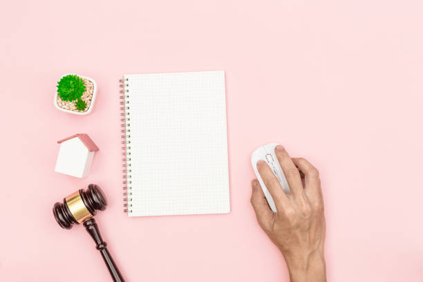 istock Top view lawyer desk, object on pink with man hand 639602610