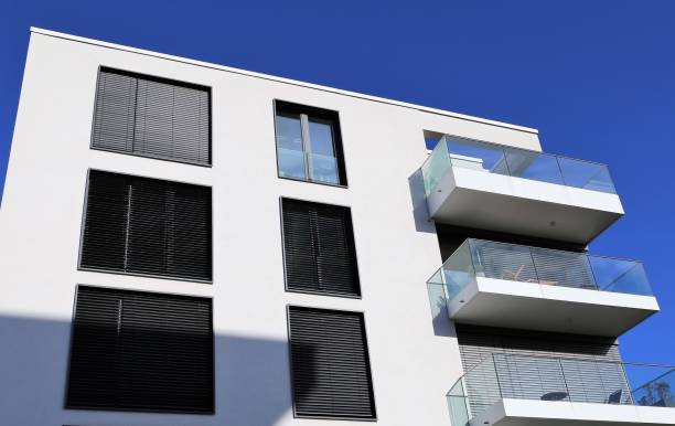 istock Windows with blinds on a apartment building 639602642