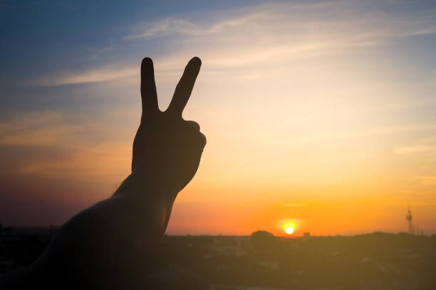 istock silhouette of a man holding up two fingers 639606876