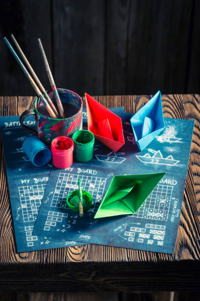 istock Homemade battleship paper game with coloured ships 639607292