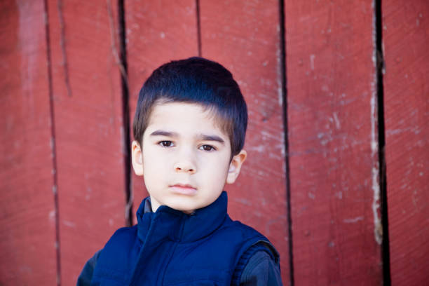 istock Serious Little Boy Making Eye Contact 639609256
