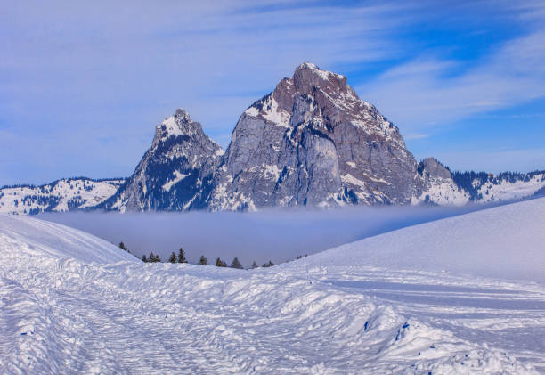 Summits of the Kleiner Mythen and Grosser Mythen in winter Summits of Kleiner Mythen and Grosser Mythen mountains rising from sea of fog, wintertime view from the village of Stoos in the Swiss Canton of Schwyz. schwyz stock pictures, royalty-free photos & images