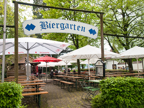 Lindau, Germany - May 2, 2015: Town Lindau- Streets of Old Town. Entry of a typical German beer garden in the town of Lindau. A beer garden is an outdoor area in which beer and local food are served, typically at shared tables. Common entertainments include music, song, and games, enjoyed in an atmosphere