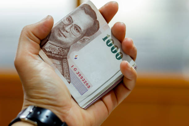 istock Thai money in hand 639611796