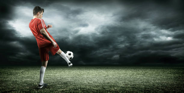 istock Football player is kicking a ball 639611880