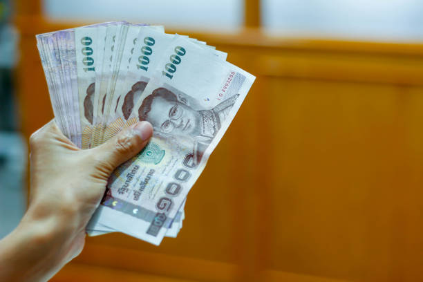 istock Thai money in hand 639611950
