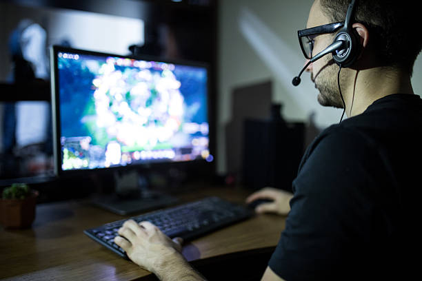 istock night play. young gamer in headphones and glasses using computer 639612496