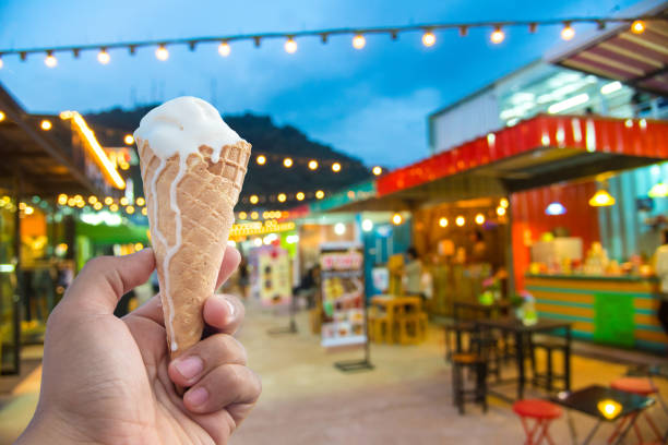 istock Man hold a cone ice cream and blurred image 639613042