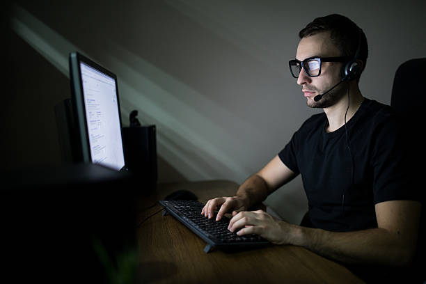 istock Man working in the night on PC and typing 639613308