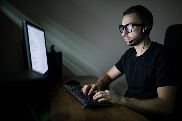 istock Man working in the night on PC and typing 639613420