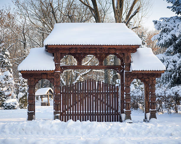 Traditional Wooden Maramures Gate Traditional wooden Maramures Gate covered in snow. maramureș stock pictures, royalty-free photos & images