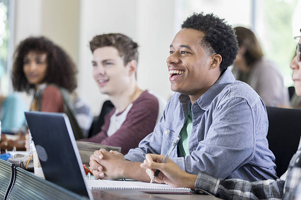 Cheerful male college student in class