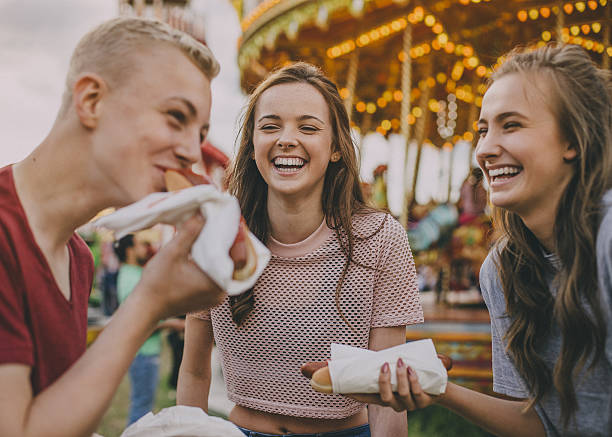 istock Teens Eating Hotdogs! 639616588
