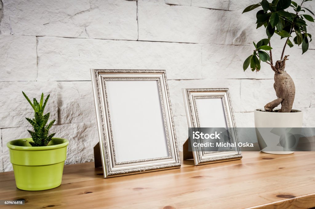 shelf with frames and flowers wooden shelf with frames and flowers against a brick wall Picture Frame Stock Photo