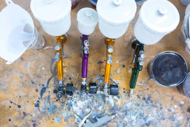 istock spray gun on wood table. in auto service. 639618240