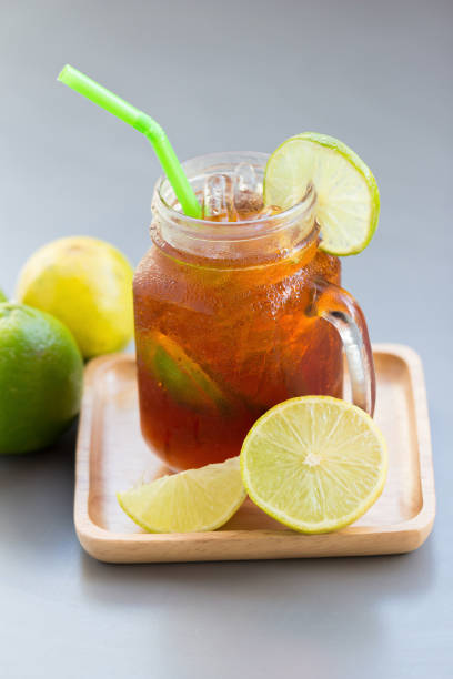istock glass of lemon juice on gray table. 639619248