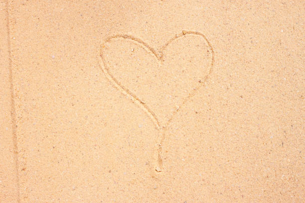 istock texture of sand surface with heart 639622152