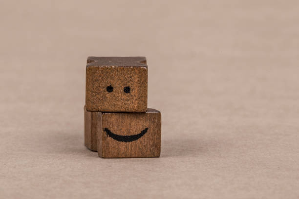 istock smiley icon on wooden cubes 639623602