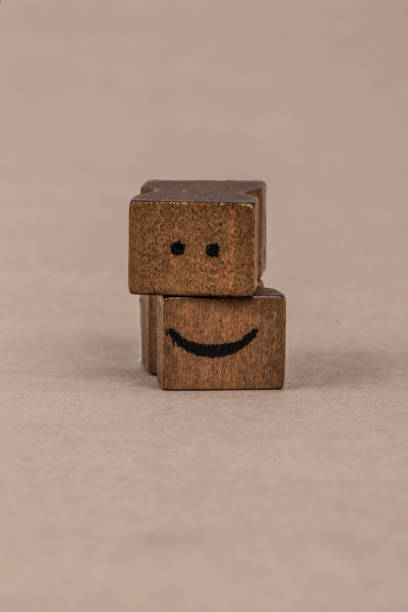 istock smiley icon on wooden cubes 639623644