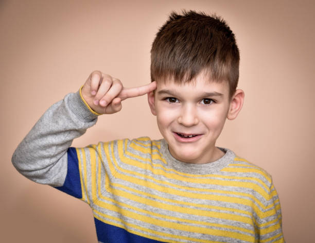 istock Young boy with the index finger on his head 639623946