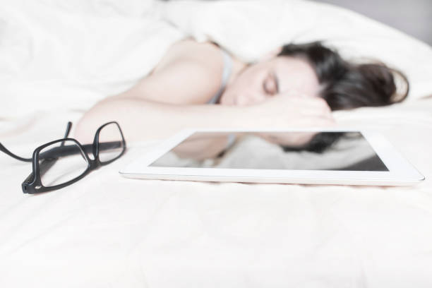 istock young woman sleeping in the bed with her digital tablet 639626132
