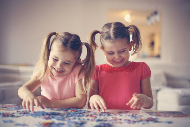 istock Two little girls playing with a puzzle. 639626898