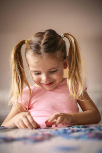 istock Girl playing puzzle. 639627134