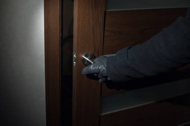 istock man wearing gloves opens the door at night 639629972