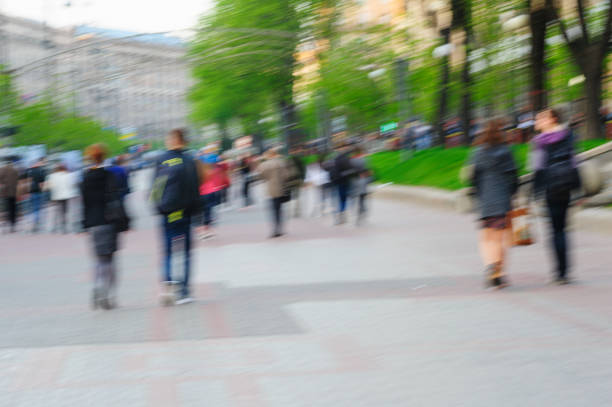 istock Blurred image of people walking at day in park with 639630192