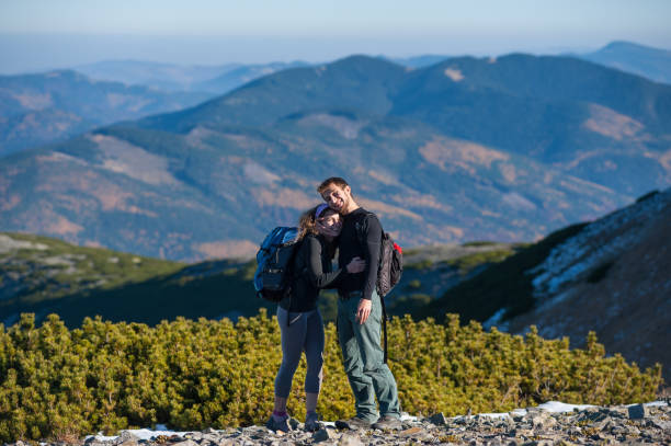 istock Happy couple backpackers enjoying mountains 639631392